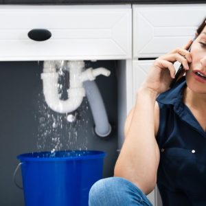 Lady on phone as she is experiencing common plumbing issues in Saskatoon